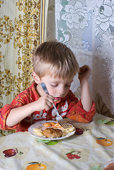 Image showing The boy has dinner