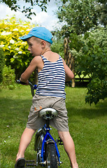 Image showing The boy with a bicycle