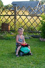 Image showing The boy is taken for a ride in a car.