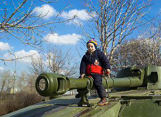 Image showing The boy sitting on the tank