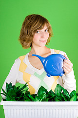 Image showing girl watering flowers