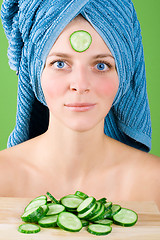 Image showing woman in blue towel and mask from cucumber