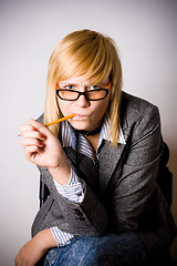 Image showing young businesswoman with pencil 