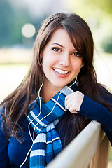 Image showing Mixed race college student listening to music