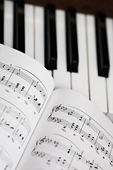 Image showing music sheet and piano