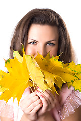 Image showing young woman with yellow leaves