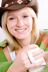 Image showing girl in a cowboy hat with cup of tea