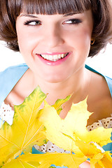 Image showing young woman with yellow leaves