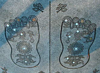 Image showing Buddha's soles with some coins(Japanese yens)from the belivers