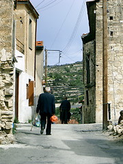 Image showing elderly cyprus man with oranges in traditional mountain village