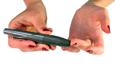 Image showing  Hands using a device for blood sampling for blood glucose self-monitoring,corect position,educational image for diabetic patients.