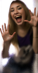 Image showing Girl behind the glass  door 