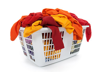 Image showing Bright clothes in laundry basket. Red, orange, yellow.