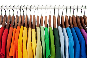 Image showing Rainbow colors, clothes on wooden hangers