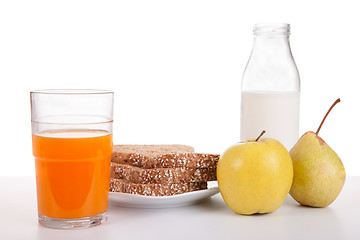 Image showing Breakfast: juice, fruit (apple and pear), bread, cereal and milk