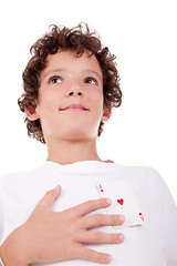 Image showing cute boy showing an ace of hearts, in place of the heart