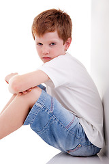 Image showing cute boy, sitting on the floor tired