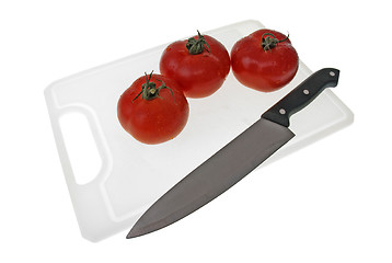 Image showing Cutting board with a knife and tomato