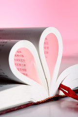 Image showing pages of a book curved into a heart shape 