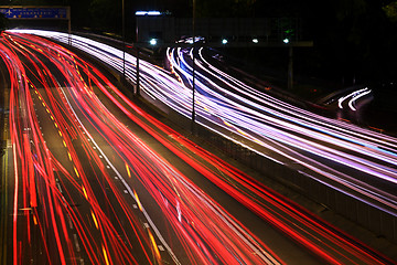 Image showing Night highway (Cars in a rush moving fast on a highway (speedway