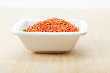 Image showing Dish with spice mixture for fish courses on wood