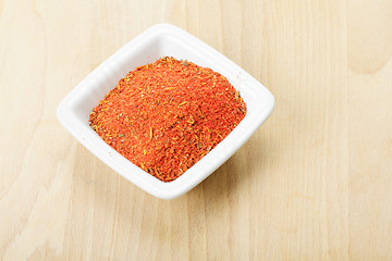 Image showing Red spice mixture for fish courses on wood