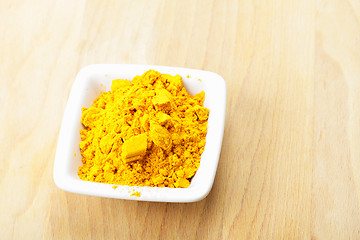 Image showing Saffron spice in white dish on wood