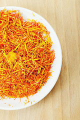 Image showing Part of dish with saffron leaves spice wood