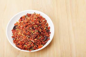 Image showing Dish with spice mixture for rice courses on wood
