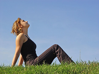 Image showing Beautiful woman sitting in the grass