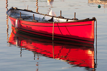 Image showing Morning light on a red boat 