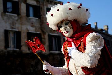 Image showing A masked woman with a red eye mask