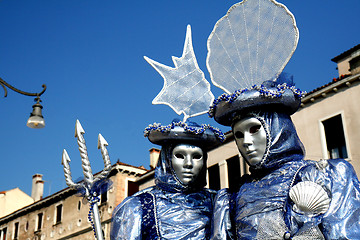 Image showing A masked couple,dressd in blue