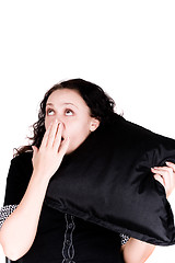 Image showing beautiful yawning woman holding a pillow