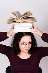 Image showing attractive woman with stack of books