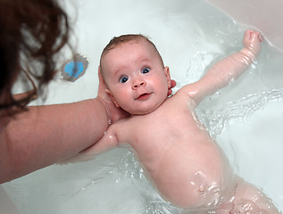 Image showing baby girl bath by mother