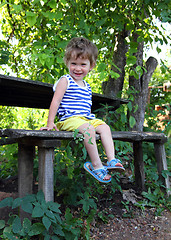 Image showing happy baby sitting in garden