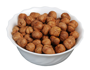 Image showing Hazelnuts on a white plate, isolated.