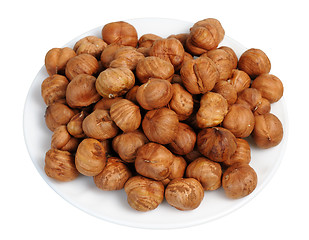 Image showing Hazelnuts on a white plate, isolated.