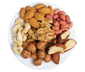 Image showing Set of nuts on a white plate, isolation