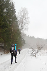 Image showing Tourists in the winter forest
