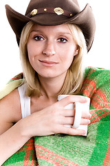 Image showing girl in a cowboy hat with cup of tea 