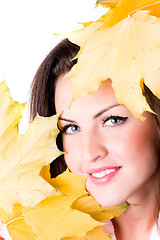 Image showing young woman with yellow leaves 