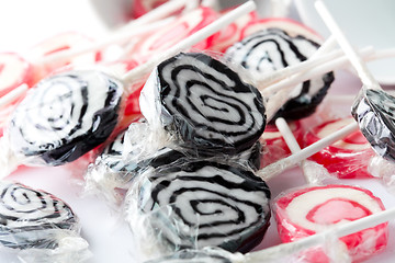 Image showing Black and pink lollipops