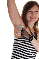 Image showing Girl putting deodorant on.