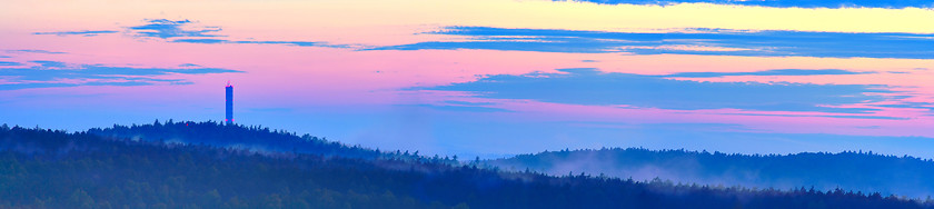 Image showing Dusk over hilly forest