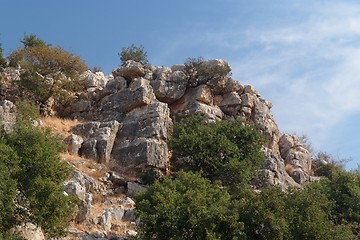 Image showing Steep weathered cliff in bright summer day