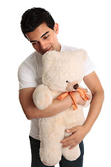 Image showing Man hugging a teddy