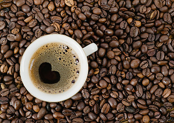 Image showing Background from coffee grains and a cup from coffee, the top vie