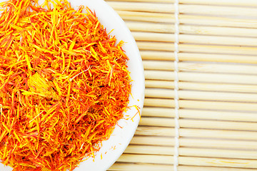 Image showing Saffron leaves spice on mat above view